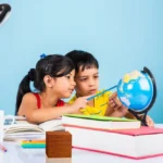 cute-little-indian-asian-kids-studying-study-table-with-pile-books-educational-globe-isolated-light-blue-colour_466689-13514